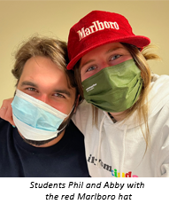Students Phil and Abby with the red Marlboro hat