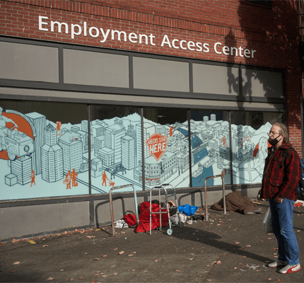 Man in front of building that says Employment Access Center