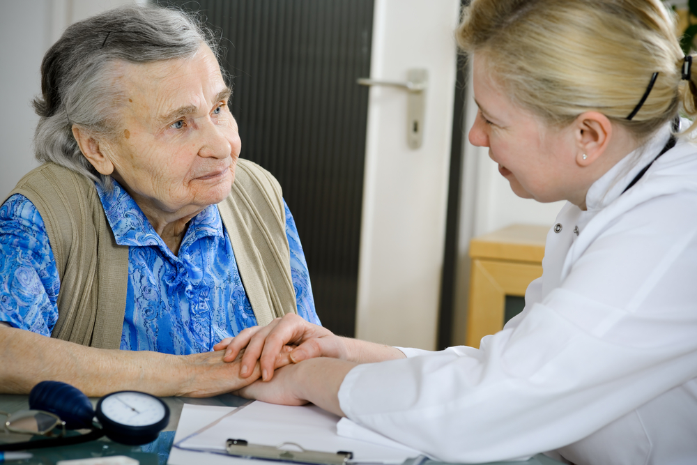 Photo - Doctor with Elderly Cancer Patient