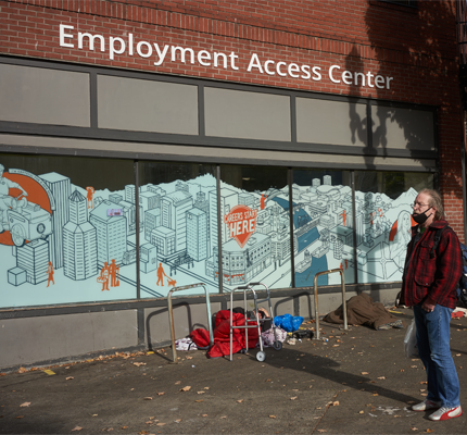 Man in front of building that says Employment Access Center